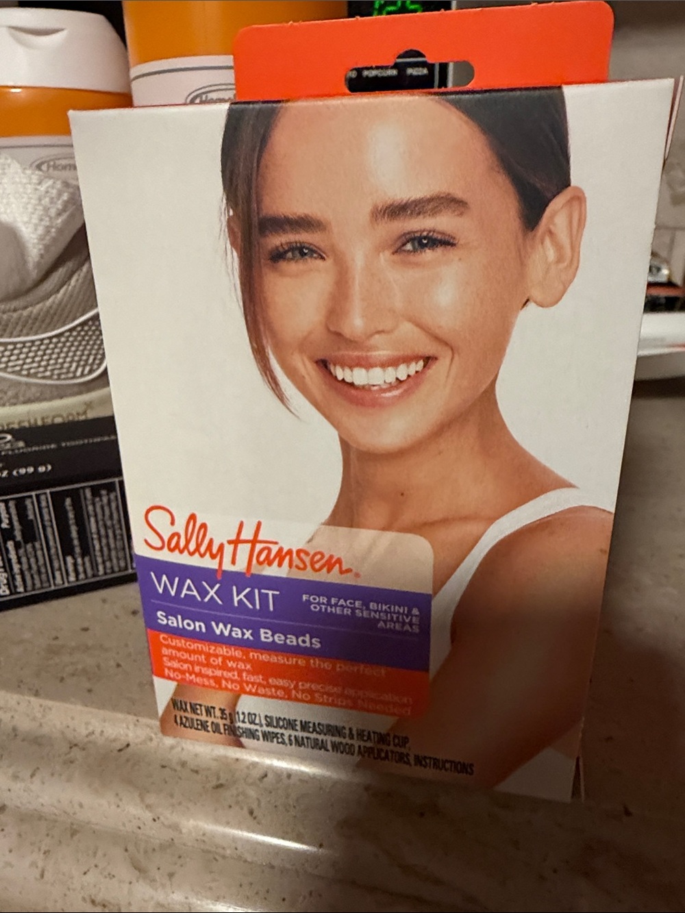 Sally Hansen Wax Your Puss Orange and White Camera Accessory tool & cream